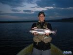 Warren with a trout at night